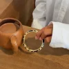Arna armbånd med blomster - Sort/guld